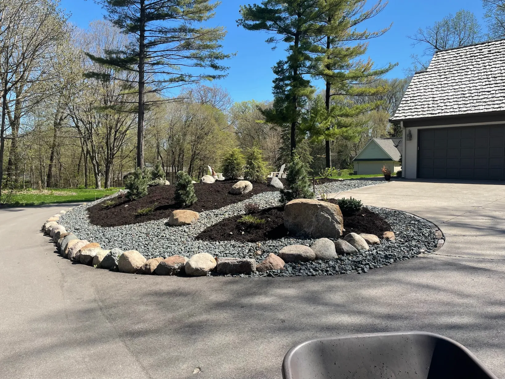 Clean river rock installation providing erosion control around a home foundation