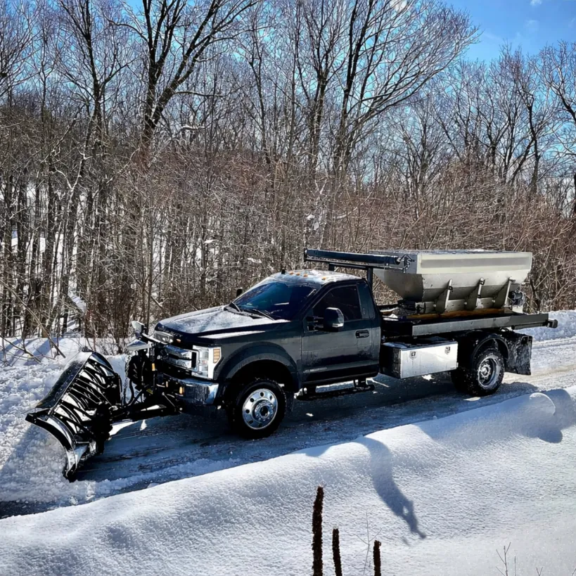 Crew member professionally shoveling a residential front walkway